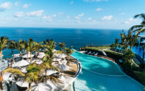 Infinity pool at luxury resort overlooking the blue sea
