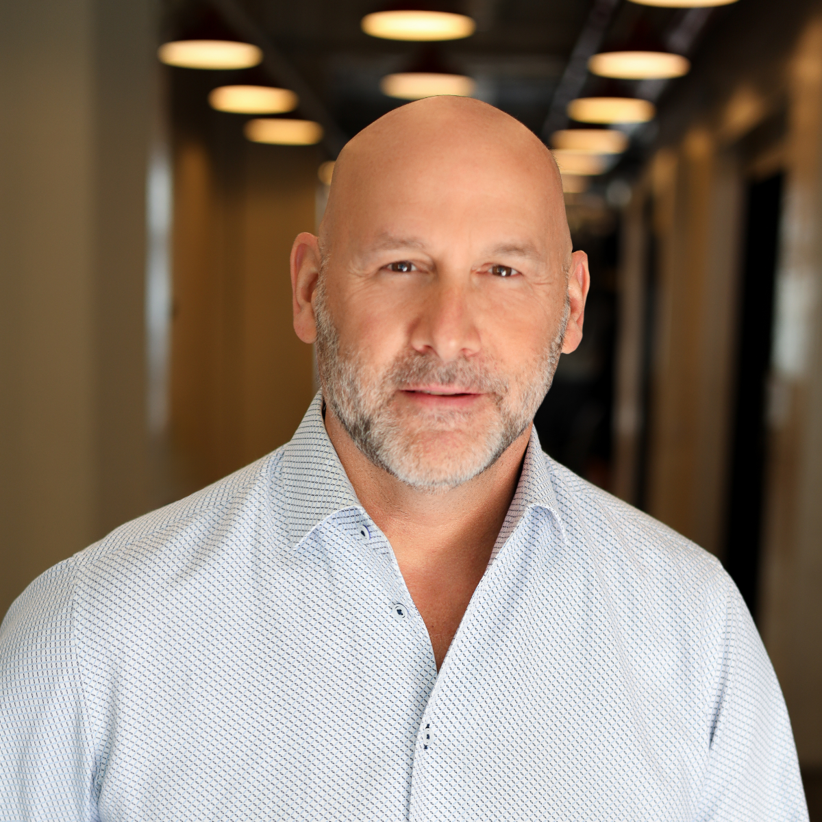headshot of man in dress shirt